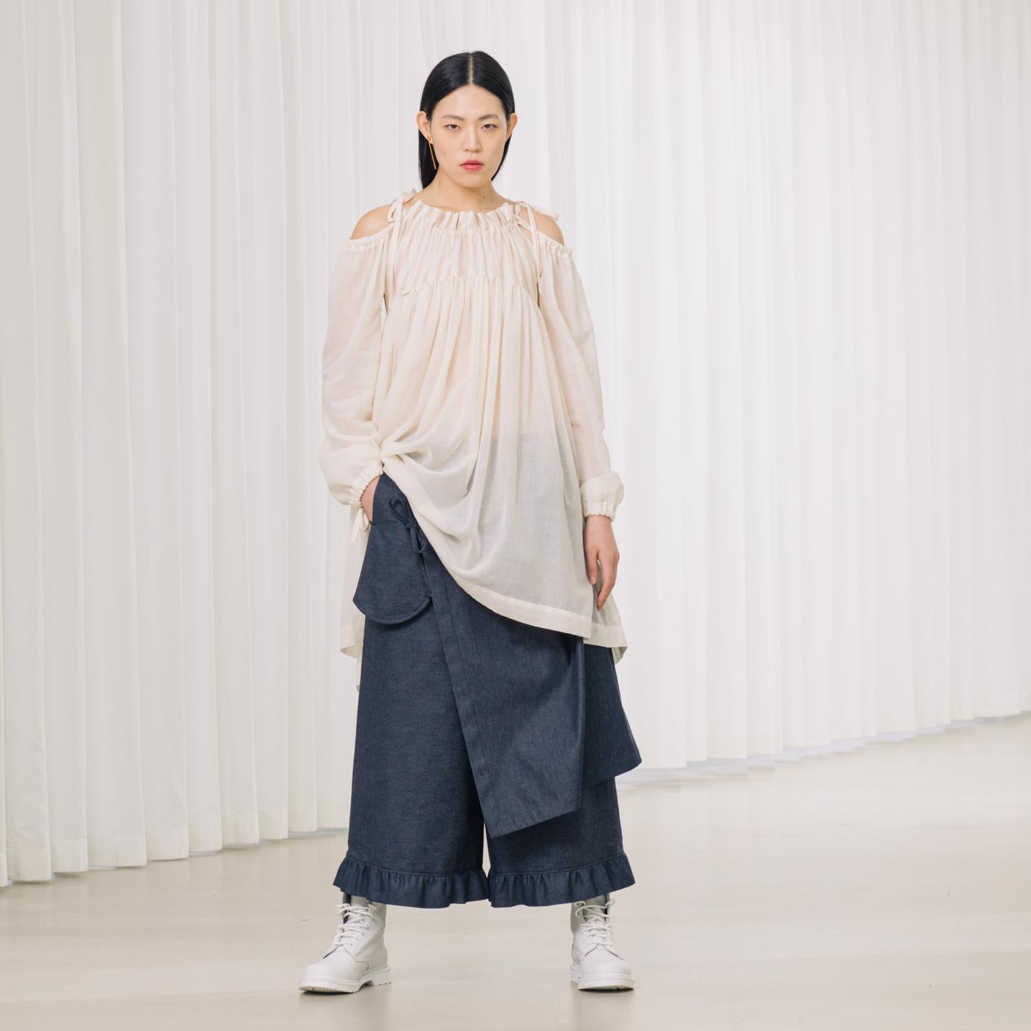 denim pants with ruffles and deconstructed drape piece