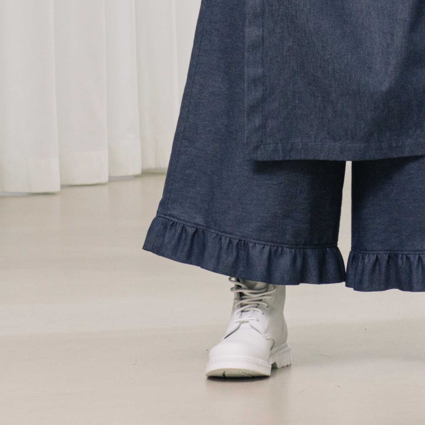 denim pants with ruffles and deconstructed drape piece
