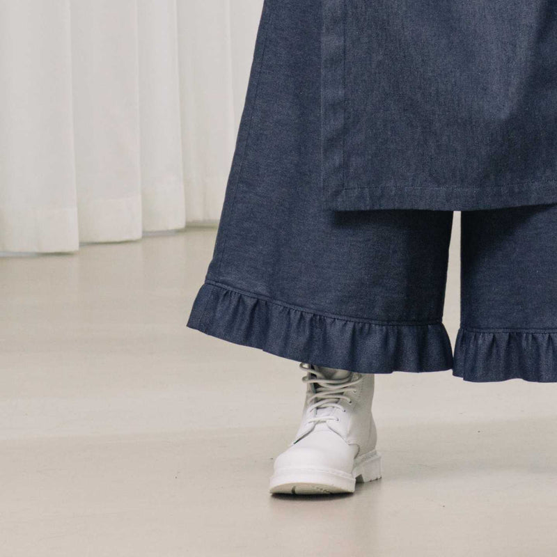 denim pants with ruffles and deconstructed drape piece