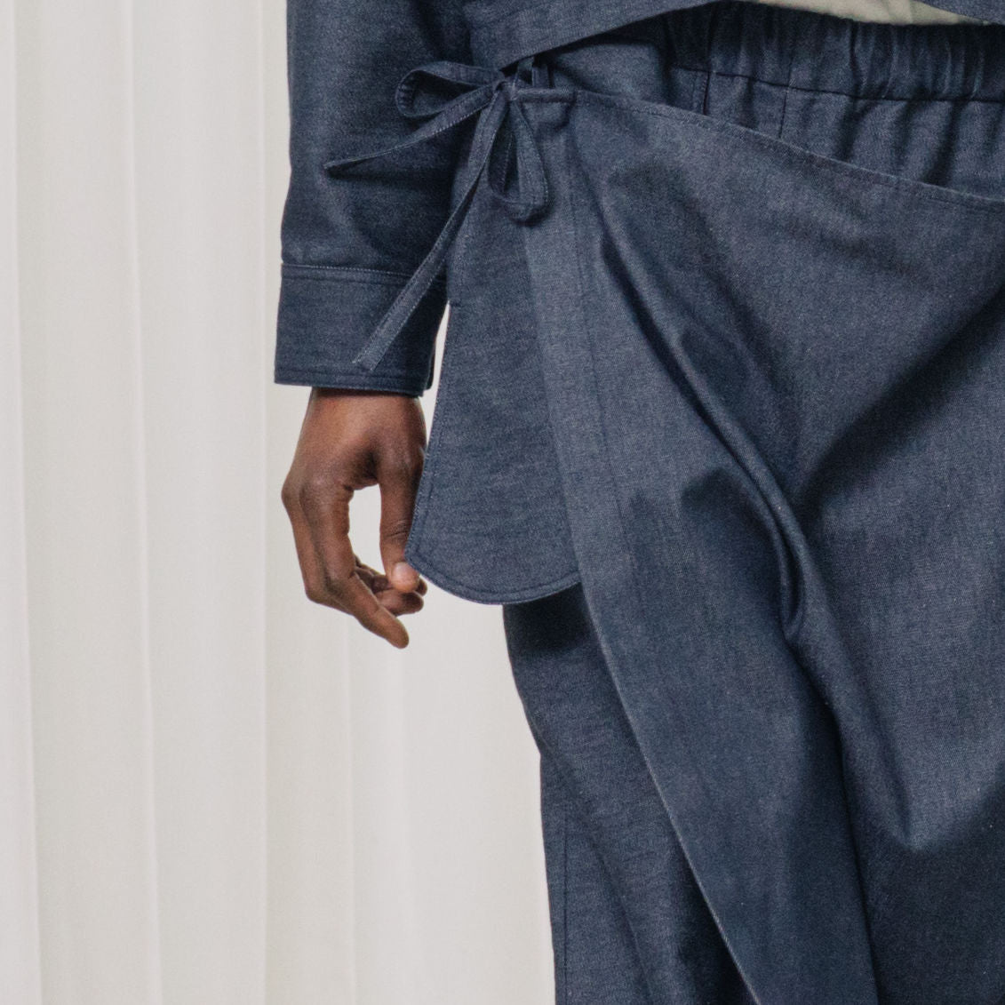 denim pants with ruffles and deconstructed drape piece