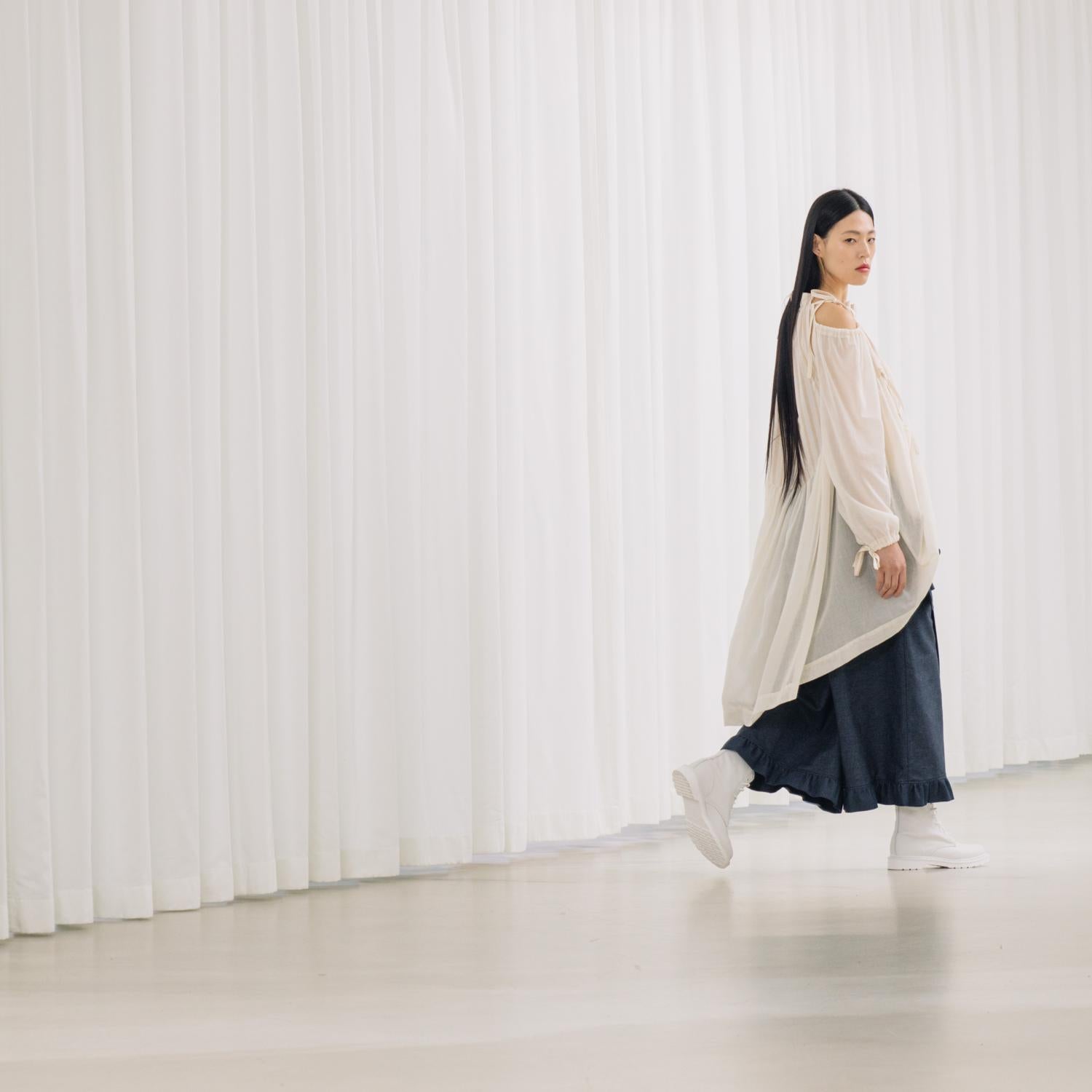 denim pants with ruffles and deconstructed drape piece