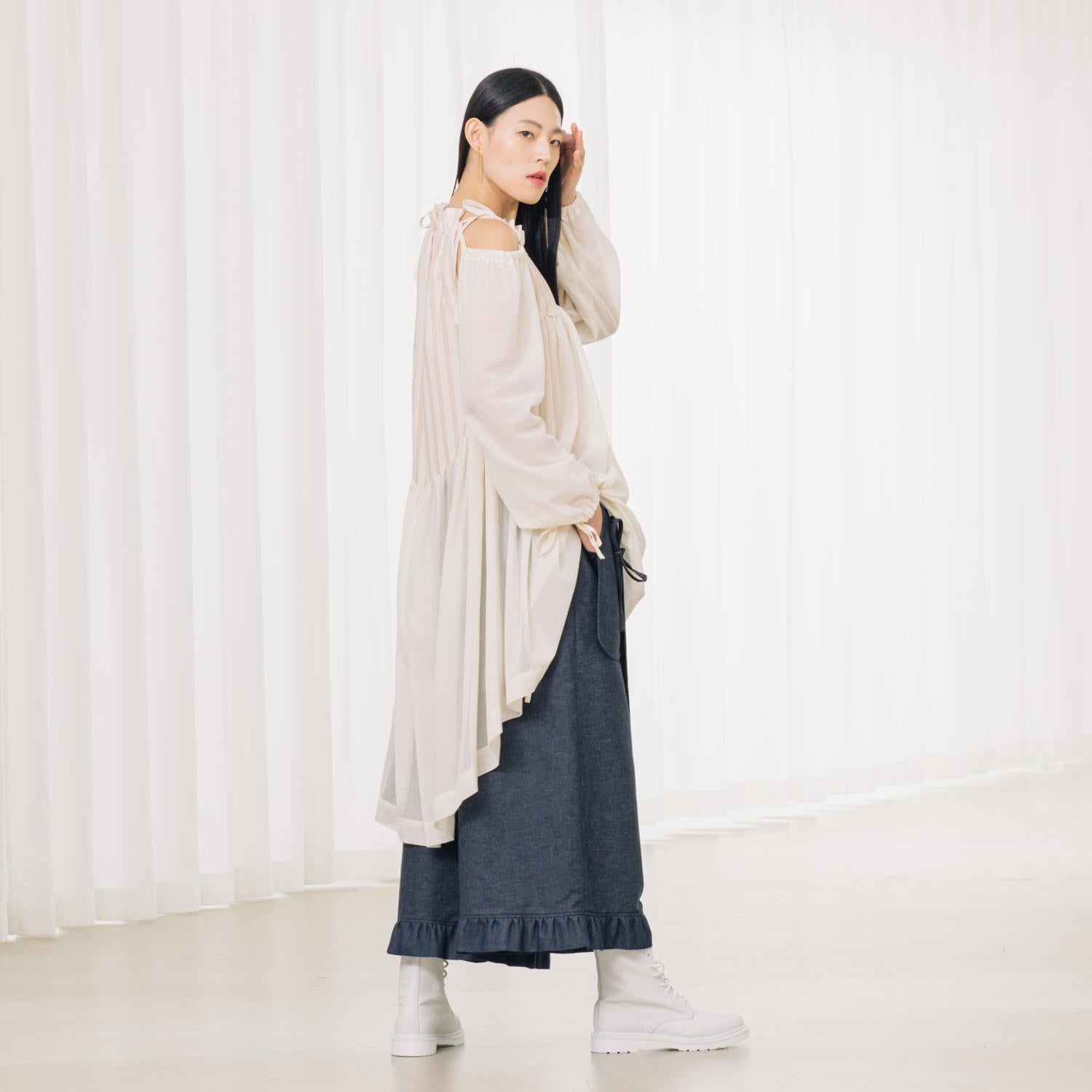 denim pants with ruffles and deconstructed drape piece