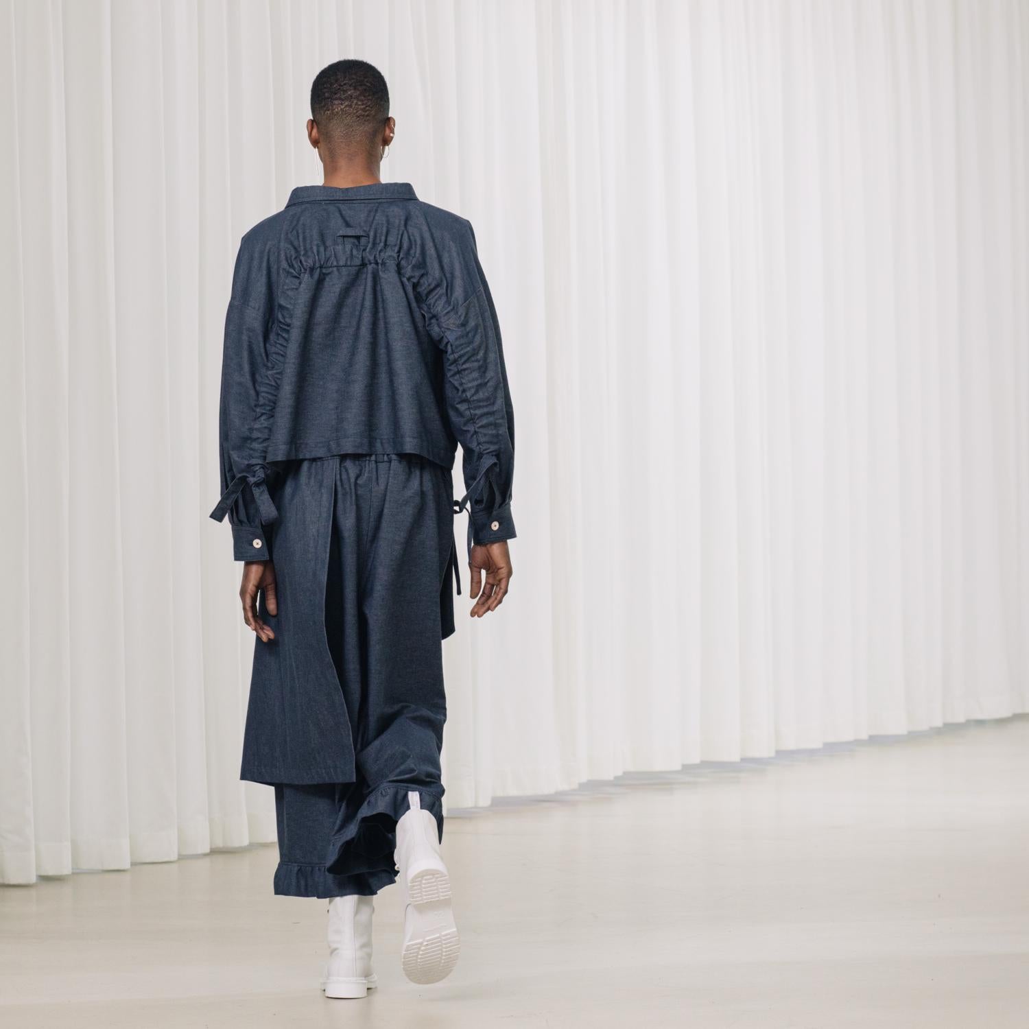 denim pants with ruffles and deconstructed drape piece