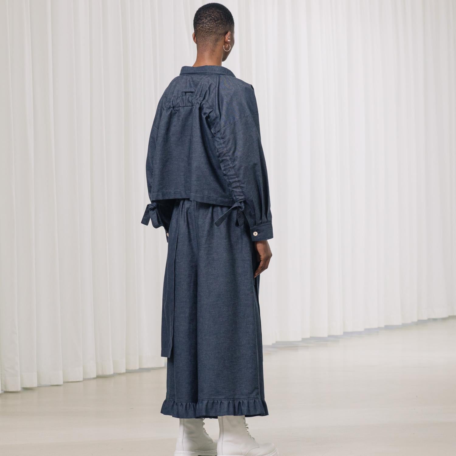 denim pants with ruffles and deconstructed drape piece