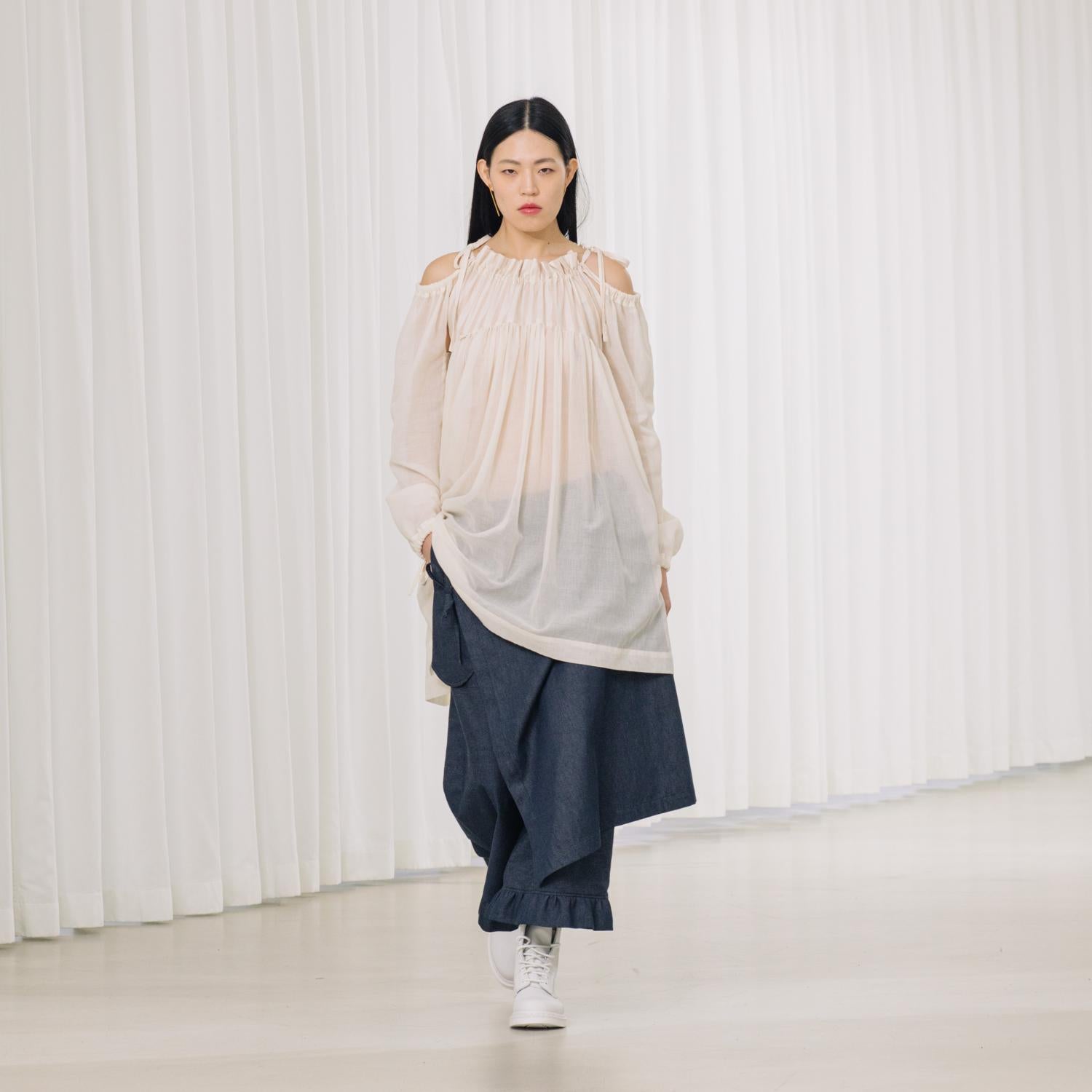 denim pants with ruffles and deconstructed drape piece